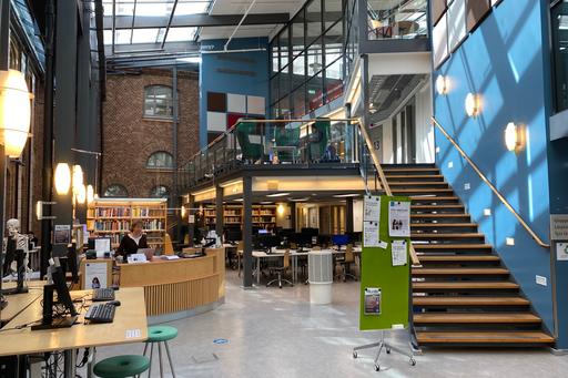The library’s information desk, staircase and study areas.